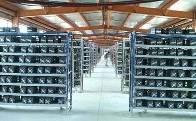 Modern mining farm with rows of hosted mining rigs