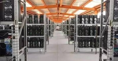 A high-tech mining farm with rows of hosting machines and cooling systems